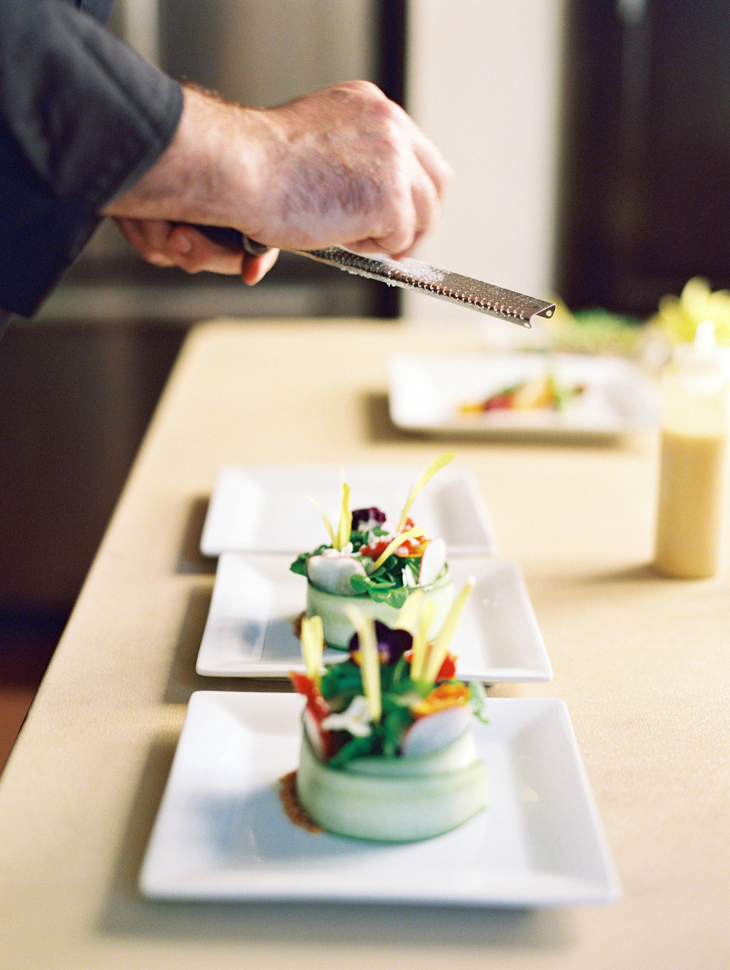 Chef plating salads for catered event